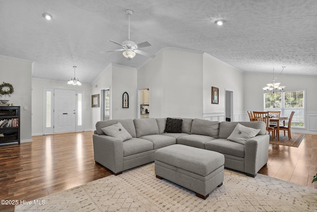 living room with lofted ceiling, a textured ceiling, and wood finished floors