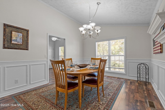 dining room featuring dark wood finished floors, visible vents, a chandelier, and a textured ceiling