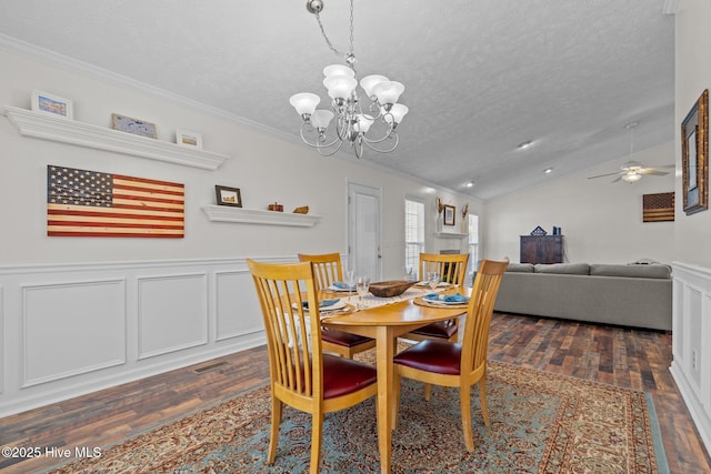 dining area featuring lofted ceiling, a textured ceiling, ornamental molding, and dark wood-style flooring