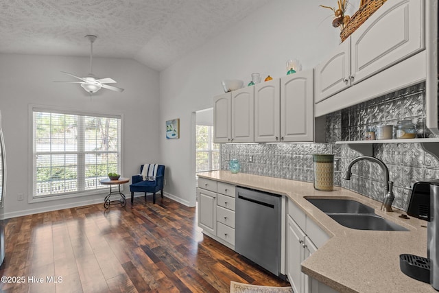 kitchen with white cabinetry, a sink, dark wood-type flooring, dishwasher, and backsplash