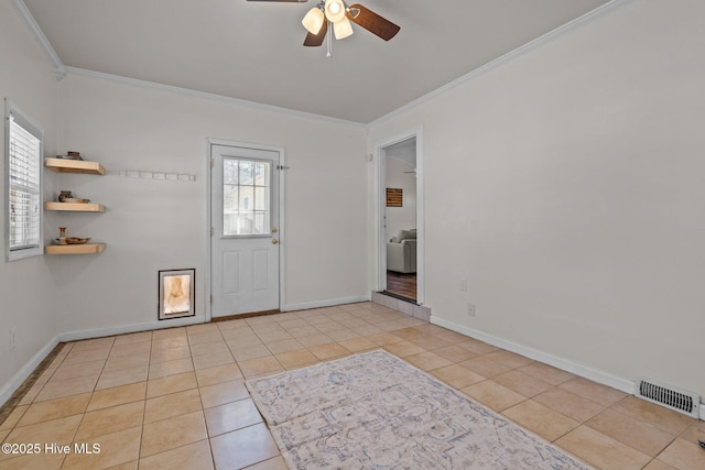 tiled entryway featuring visible vents, ceiling fan, baseboards, and ornamental molding