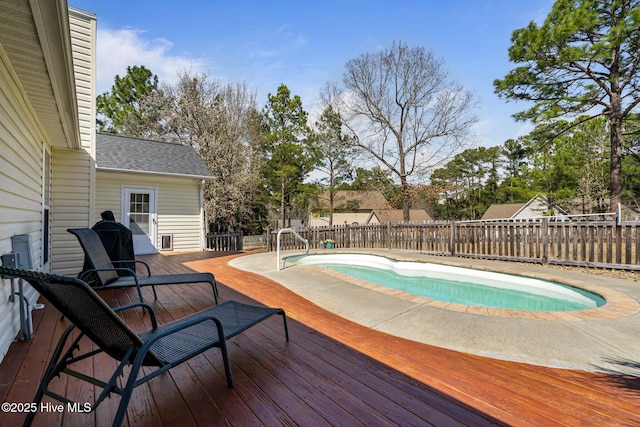 view of pool with a fenced in pool, a wooden deck, and a fenced backyard