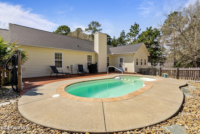 view of pool featuring a wooden deck and fence