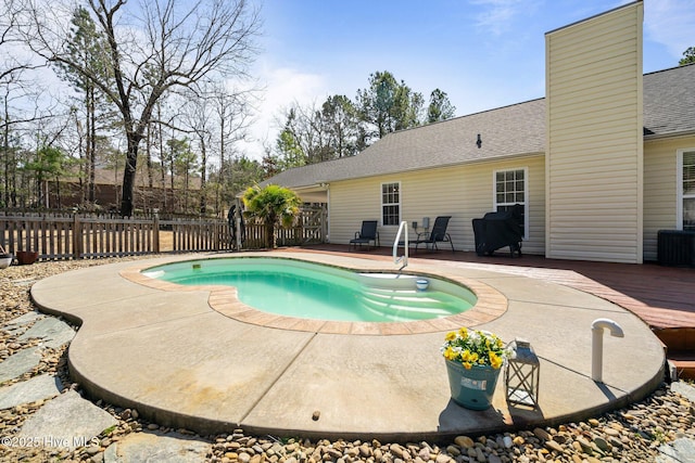 view of pool with a deck, a patio, and fence