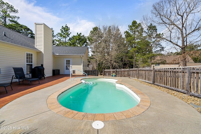 view of swimming pool featuring a wooden deck, a fenced in pool, and a fenced backyard