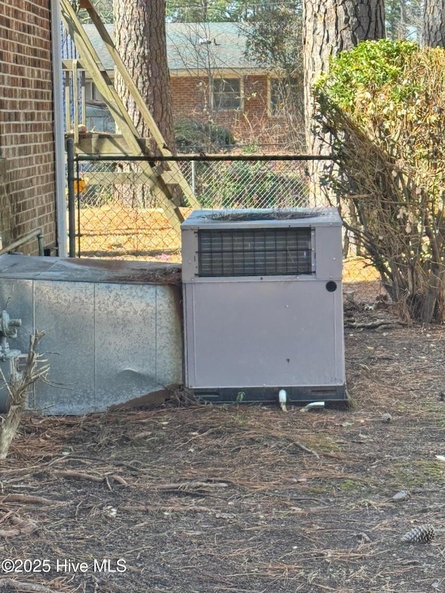 details featuring central air condition unit and fence