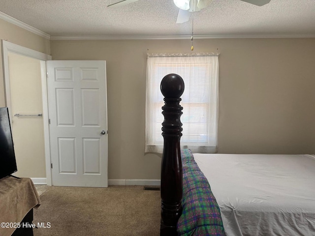 carpeted bedroom featuring a textured ceiling, ornamental molding, visible vents, and baseboards