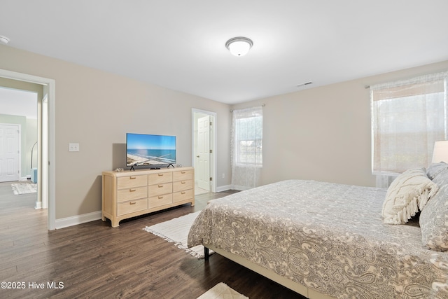 bedroom featuring dark wood-type flooring, visible vents, and baseboards