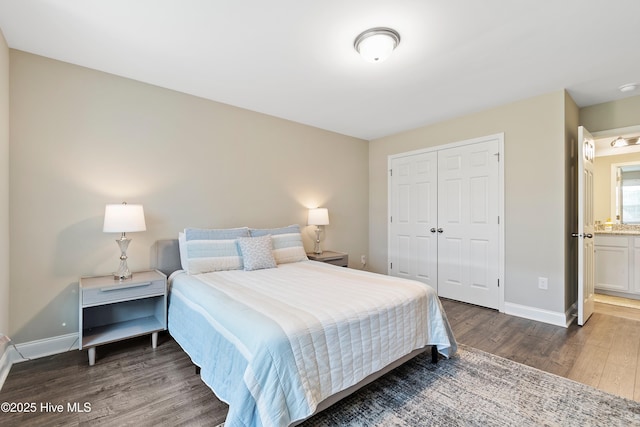 bedroom featuring dark wood-type flooring, a closet, and baseboards