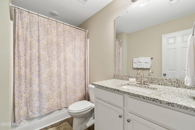 full bathroom featuring toilet, shower / bath combination with curtain, wood finished floors, and vanity