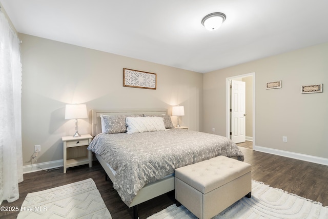 bedroom featuring dark wood-style flooring and baseboards