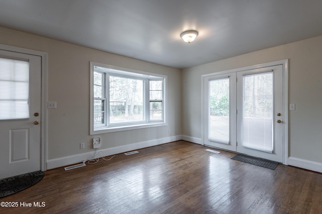 interior space featuring visible vents, baseboards, and wood finished floors