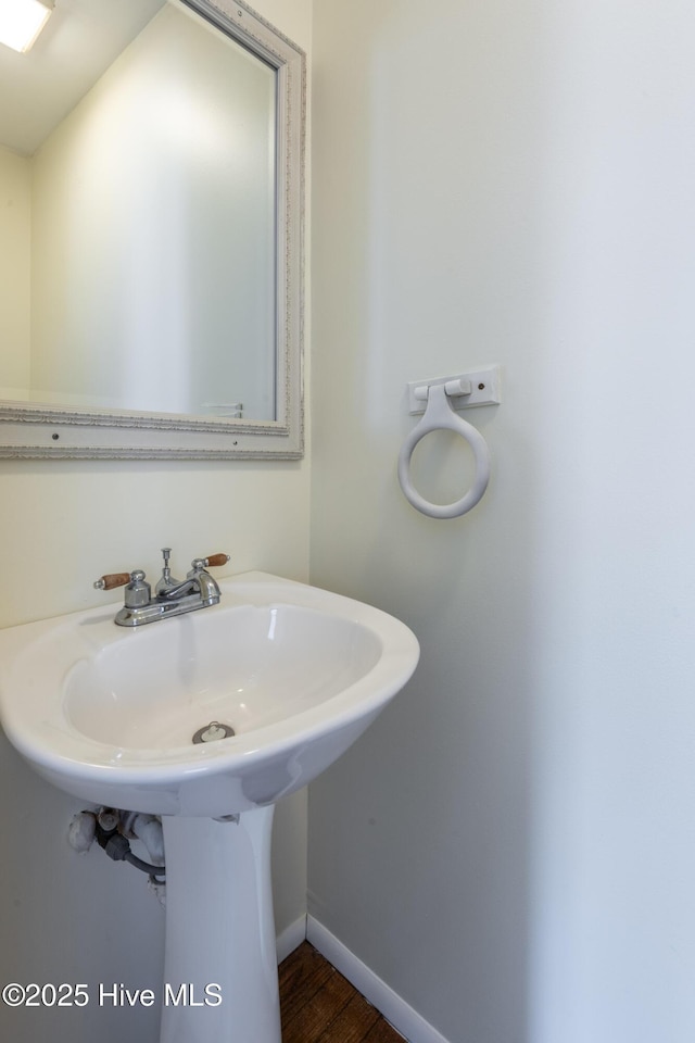 bathroom featuring baseboards and wood finished floors