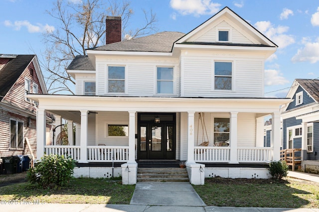 view of front of home featuring covered porch, roof with shingles, and a chimney