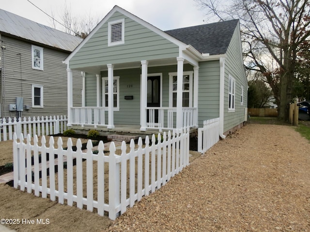 bungalow featuring a porch, roof with shingles, and a fenced front yard