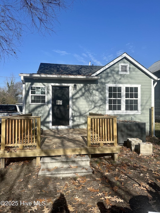 back of property with a wooden deck