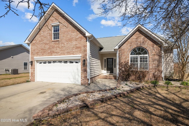 traditional home featuring brick siding, central AC, concrete driveway, and roof with shingles