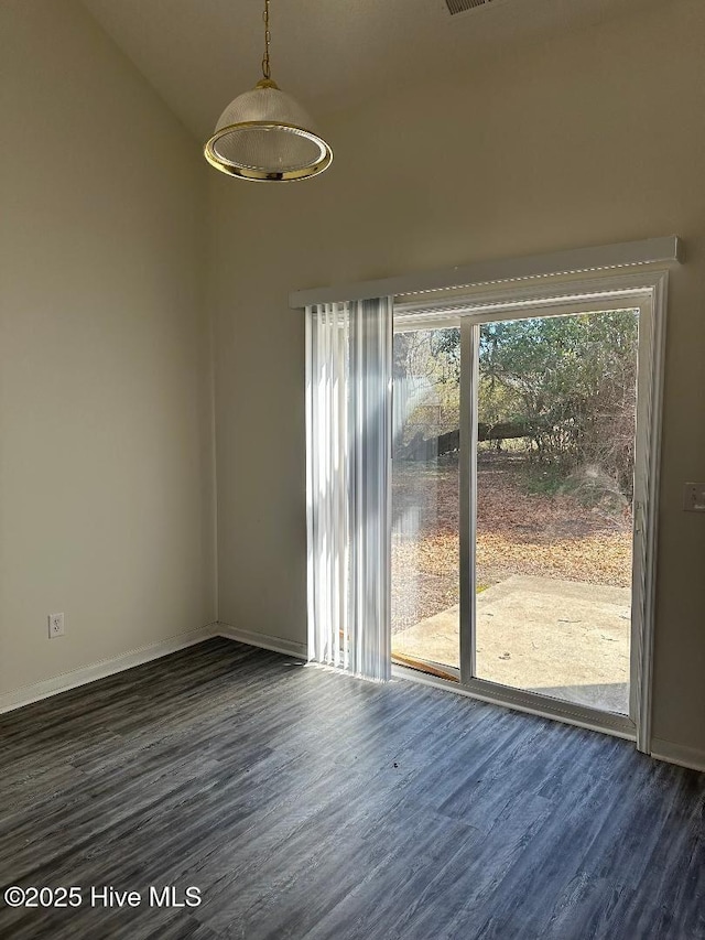 empty room with baseboards and wood finished floors