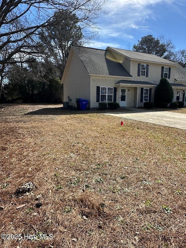 traditional home featuring driveway and cooling unit