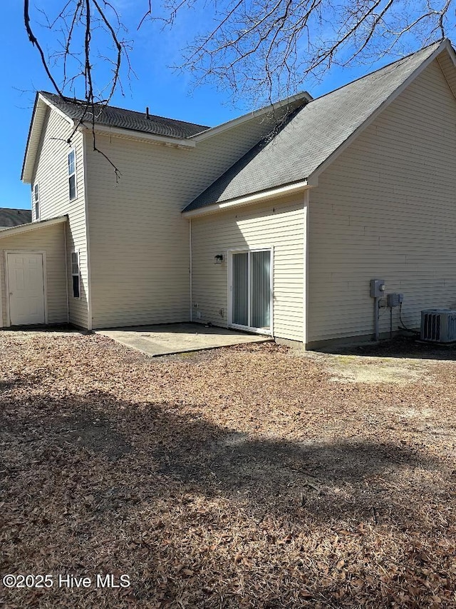 rear view of house featuring a patio and central AC unit