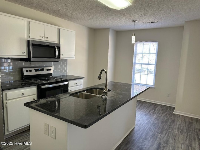 kitchen with visible vents, decorative backsplash, dark wood finished floors, appliances with stainless steel finishes, and a sink