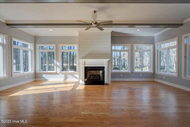 unfurnished living room with a fireplace with flush hearth, beamed ceiling, ornamental molding, and wood finished floors