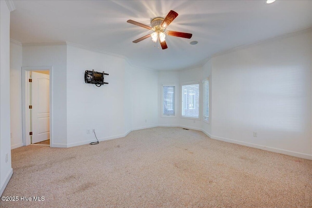 empty room with crown molding, ceiling fan, and carpet floors