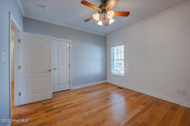 unfurnished room featuring baseboards, ceiling fan, ornamental molding, and light wood-style floors