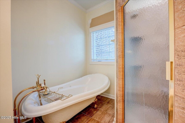 full bathroom with crown molding, a freestanding bath, and a shower stall