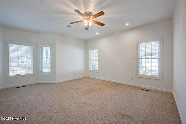 unfurnished room with ornamental molding, baseboards, visible vents, and carpet flooring