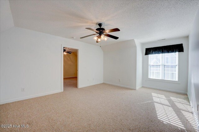 unfurnished room with ceiling fan, ornamental molding, carpet flooring, and baseboards