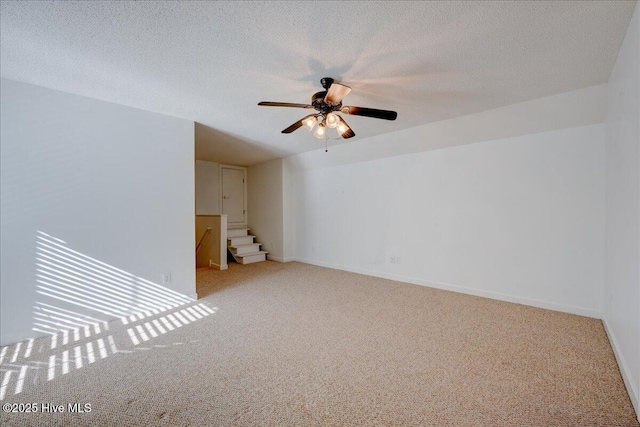 3602 Cranberry Ln, New Bern, NC 28562 - spare room with carpet, a ceiling fan, stairs, baseboards, and a textured ceiling