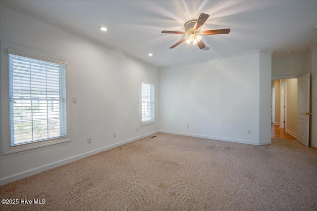 empty room with recessed lighting, light colored carpet, ornamental molding, ceiling fan, and baseboards