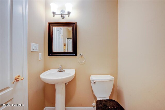 bathroom with a stall shower, crown molding, visible vents, and a sink