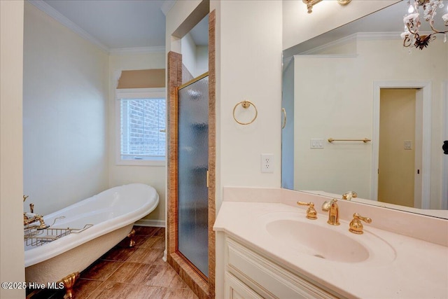 full bathroom featuring ornamental molding, a freestanding bath, vanity, a shower stall, and a chandelier