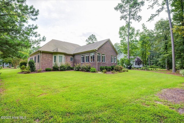 view of front of property with a front lawn and brick siding