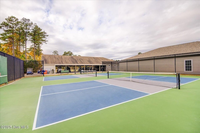 view of tennis court featuring fence and community basketball court