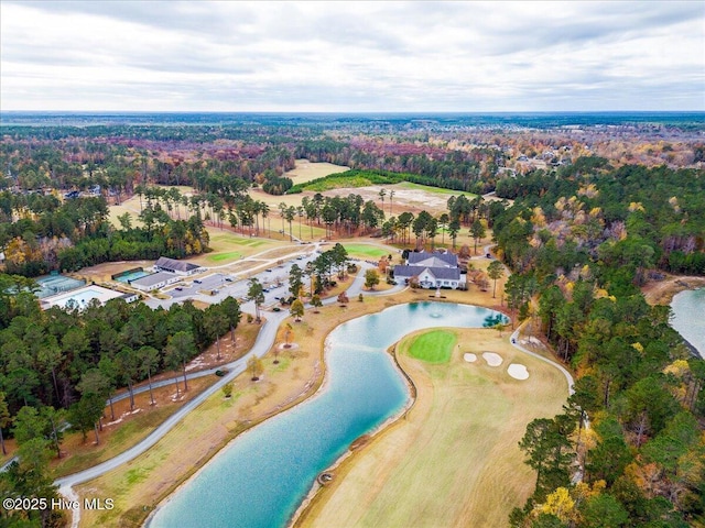 aerial view with a water view and a forest view