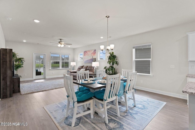 dining room featuring ceiling fan with notable chandelier, recessed lighting, baseboards, and wood finished floors