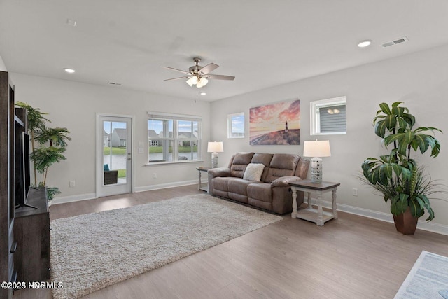 living area featuring recessed lighting, visible vents, ceiling fan, wood finished floors, and baseboards