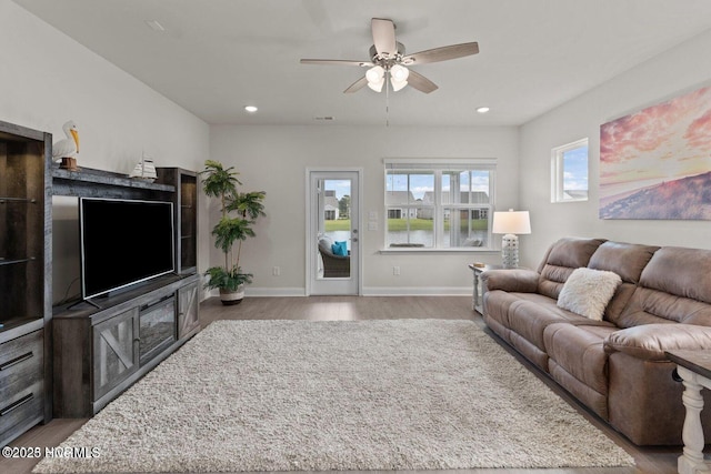 living area with ceiling fan, recessed lighting, wood finished floors, and baseboards