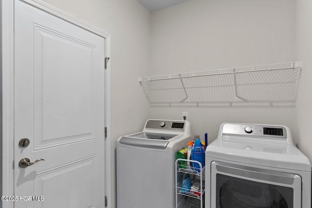 washroom featuring laundry area and washer and clothes dryer