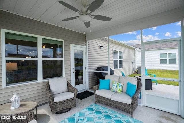 sunroom / solarium with a ceiling fan