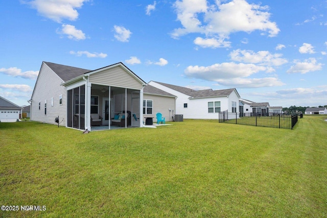 back of property featuring a lawn, cooling unit, a sunroom, and fence