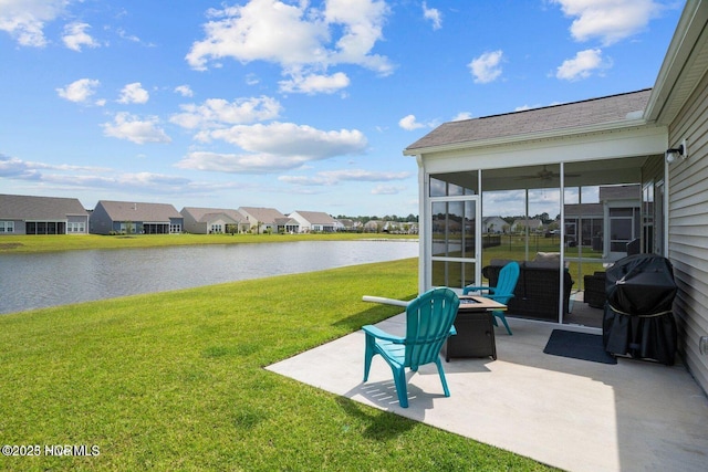 exterior space featuring a patio area, a water view, a residential view, and a sunroom