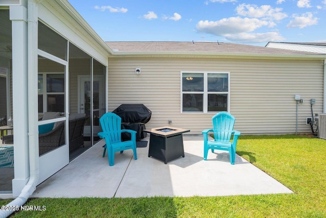 view of patio / terrace with a sunroom, an outdoor fire pit, and area for grilling