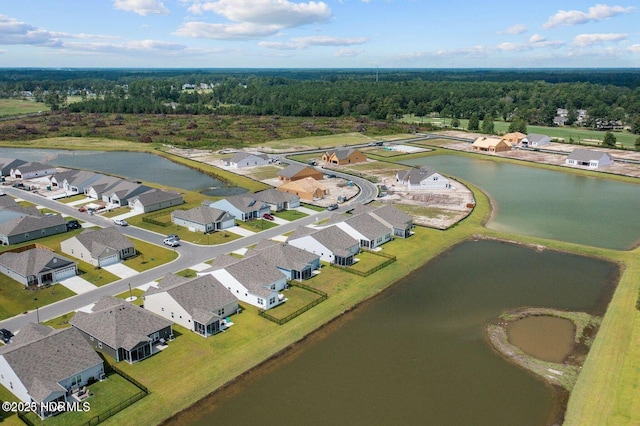 birds eye view of property with a water view, a residential view, and a wooded view