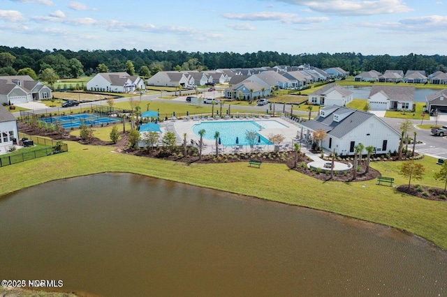 drone / aerial view featuring a residential view and a water view