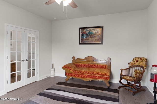 sitting room with ceiling fan, french doors, wood finished floors, and baseboards