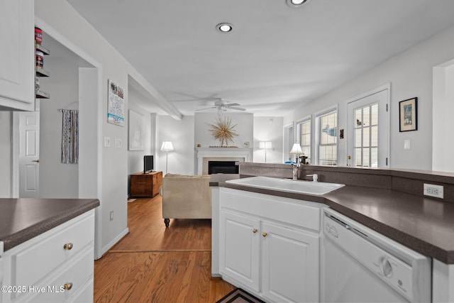 110 SE 7th St, Oak Island, NC 28465 - kitchen with white dishwasher, dark countertops, a ceiling fan, a sink, and recessed lighting